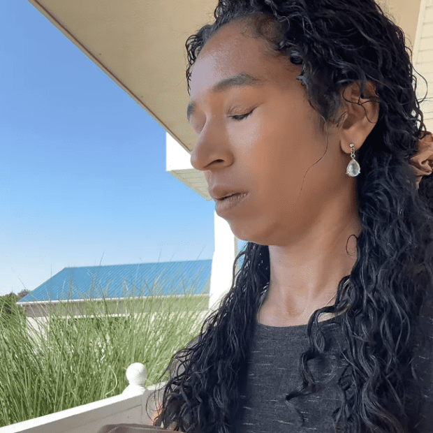 Natalie in a quiet moment outdoors under blue sky