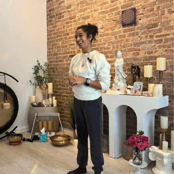 Natalie speaking at a Quantum Healing Workshop in New York City with singing bowls, gong, and altar